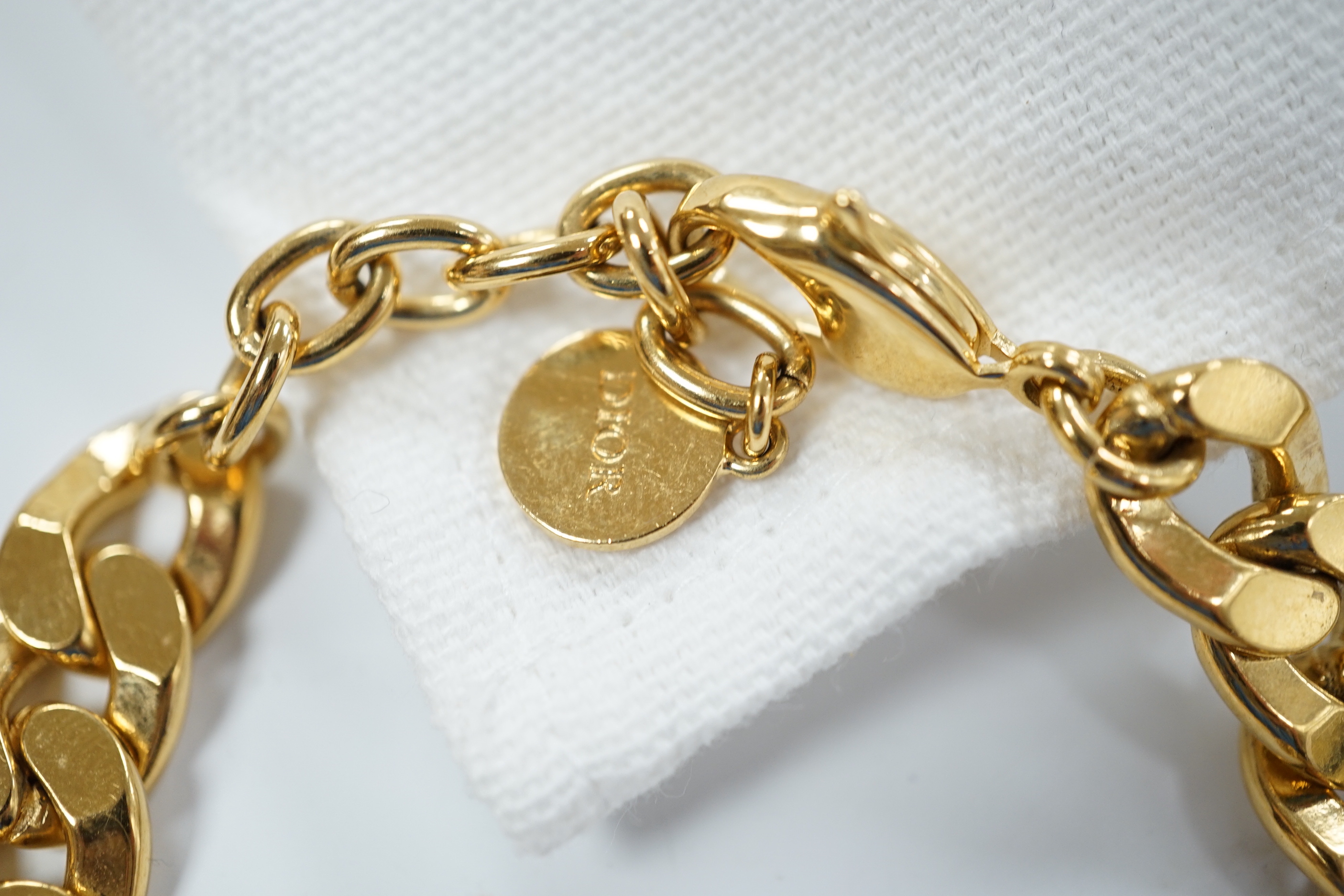A Christian Dior Danseuse Etoile gilt bracelet, 18cm, with Dior box and pamphlet etc. together with a Luciani Murano glass bead twist necklace, 48cm.